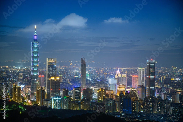 Fototapeta Urban Splendor at Night: Watching Dynamic Clouds Above a Dazzling Cityscape. View of Taipei city from the Four Beasts Mountain Trail, Taiwan