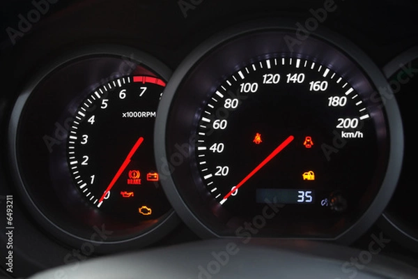 Fototapeta Closeup shot of a speedometer and tachometer of a modern car.