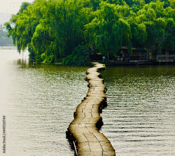 Fototapeta A floating path on the lake leading to a small island on the other side