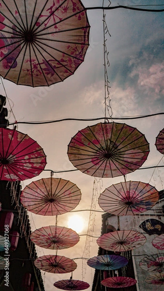 Obraz In a small town in Hangzhou, China, colorful umbrellas line the streets