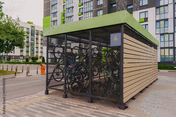 Obraz Bicycle garage. Bicycles in a cage on the street. Special garage-cage for bicycles. Bicycle storage device.