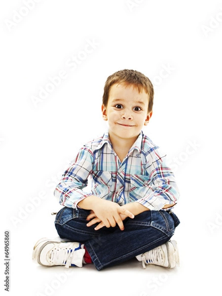 Obraz Smiling little boy sitting down on floor in jeans