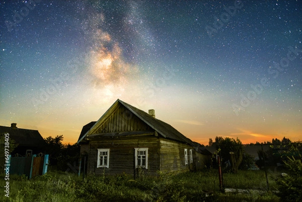 Fototapeta A farm house on the background of The Milky Way in the countryside at night in summer 