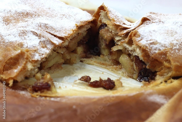 Fototapeta Typical artisanal cake strudel with apples and raisins and cinnamon-