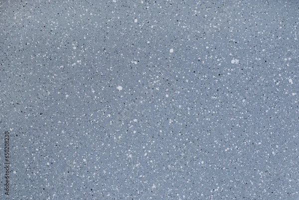 Fototapeta Abstract texture of white and black dots on a gray background. The surface of the frying pan.