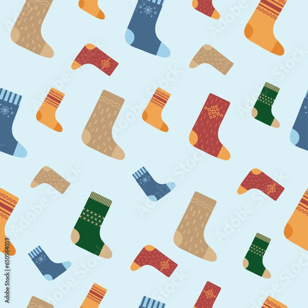 Fototapeta Seamless pattern with woolen socks of different colors and with different patterns on a blue background. Vector illustration