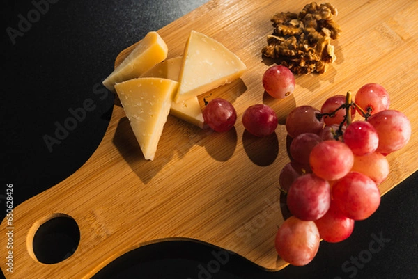 Obraz cheese board with grapes and nuts
