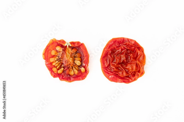 Fototapeta A dried cherry tomato sliced in half on white background