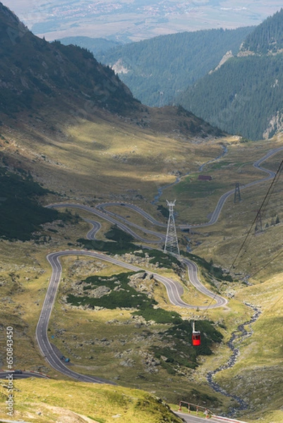 Fototapeta Red cable car to Balea Lake over the famous mountain Transfagarasan Road, Carpathian Moutains, Romania. Vertical frame