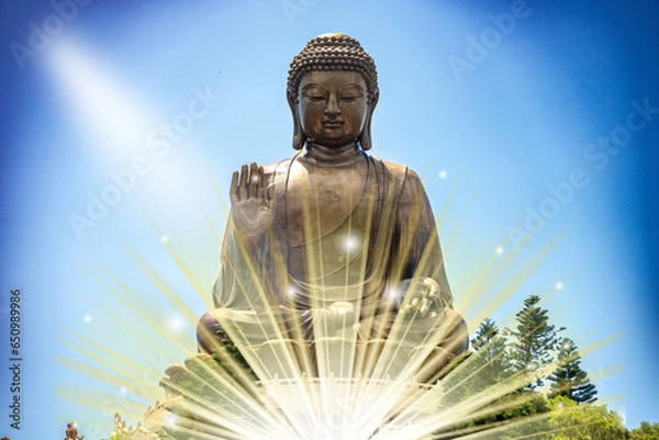 Fototapeta The Tian Tan Buddha in Hong Kong, with a radiant glow above and in front of the statue