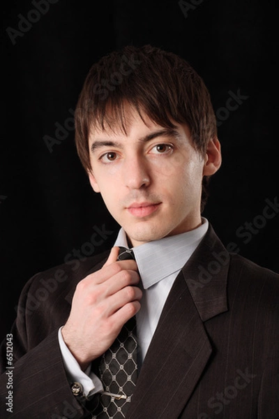 Obraz Man in suit corrects tie