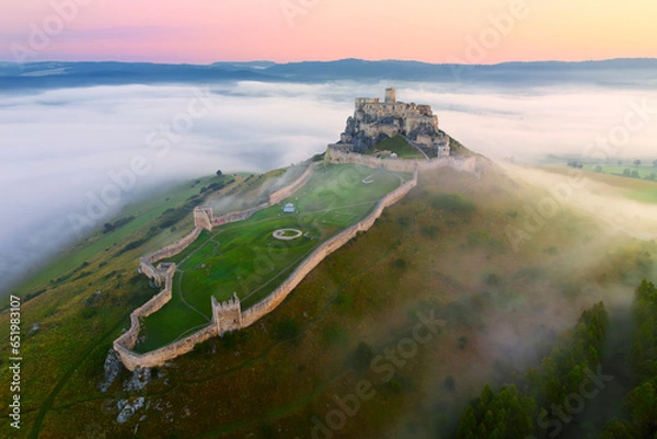 Fototapeta Spis Castle (Spissky hrad, Slovakia) - one of the most impressive castles in Central Europe on fogy summer morning