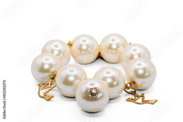 Obraz old bangle bracelet made from pearl color plastic and  gold metal isolated on  white background,macro photo,has path