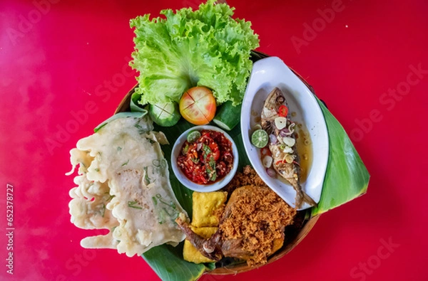 Fototapeta Top view of Sundanese Nasi Liwet main course, a traditional culinary from West Java, Indonesia.