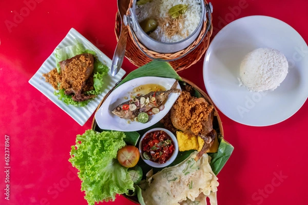 Fototapeta Top view of Sundanese Nasi Liwet main course, a traditional culinary from West Java, Indonesia.