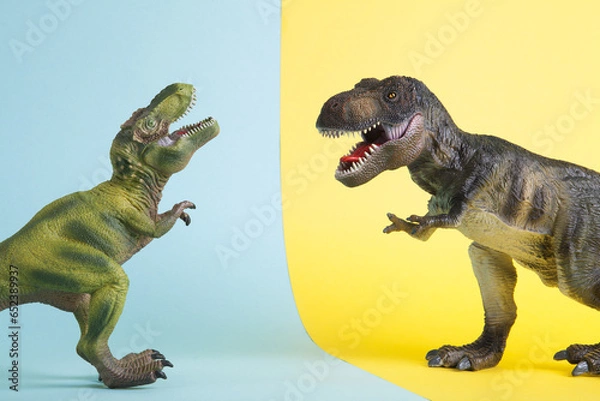 Obraz 2 dinosaurs fighting on a yellow and blue background