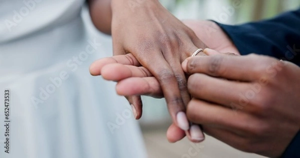 Fototapeta Couple, holding hands and ring for marriage, love or wedding in ceremony, commitment or support. Closeup of people getting married, vows or accessory for symbol of bond, relationship or partnership