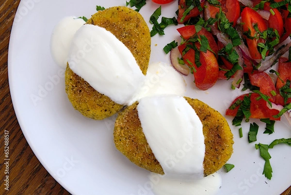 Fototapeta broccoli potato rissoles with sour cream and tomato salad