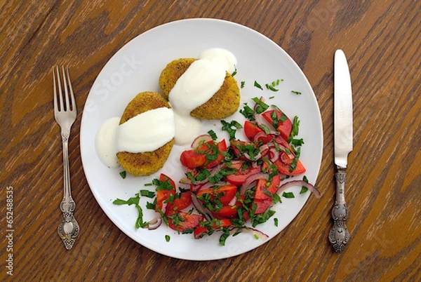 Fototapeta broccoli potato rissoles with sour cream and tomato salad