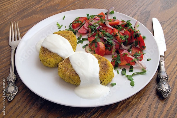 Fototapeta broccoli potato rissoles with sour cream and tomato salad