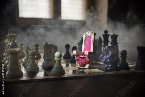 Fototapeta Red royal chair miniature on wooden table. Medieval Throne on chessboard. Chess board game concept of business ideas and competition and strategy ideas concept. Selective focus