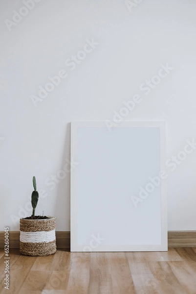 Fototapeta Blank white canvas mock-up on white wall. Modern style interior with poster artwork template. Blank empty copy space frame mockup.