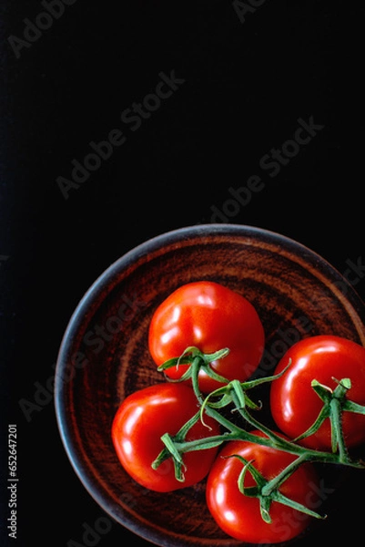 Obraz tomatoes on a plate on a black background