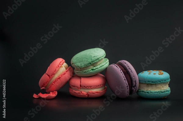 Obraz crushed multi-colored macaroons on a black background