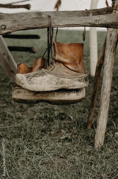 Obraz boots on a fence