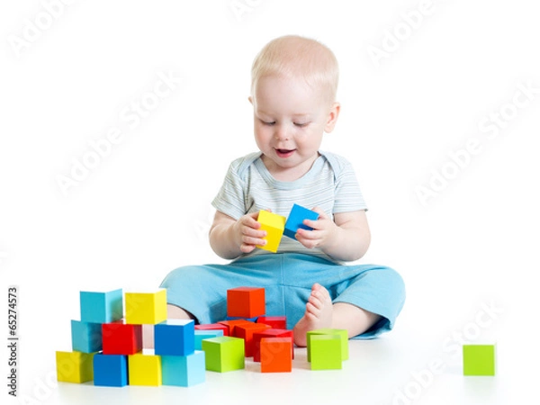 Fototapeta Child boy playing toy blocks isolated on white background