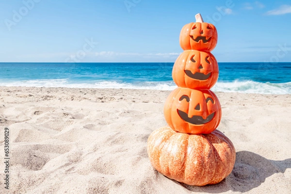Fototapeta Happy Halloween background with pumpkins on the beach
