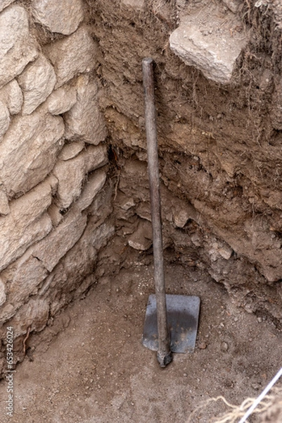 Fototapeta A hoe in an archaeological excavation. Work tools