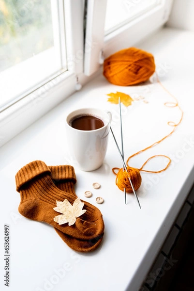 Obraz Set for knitting children's socks. Orange threads, knitting needles, buttons, centimeter.