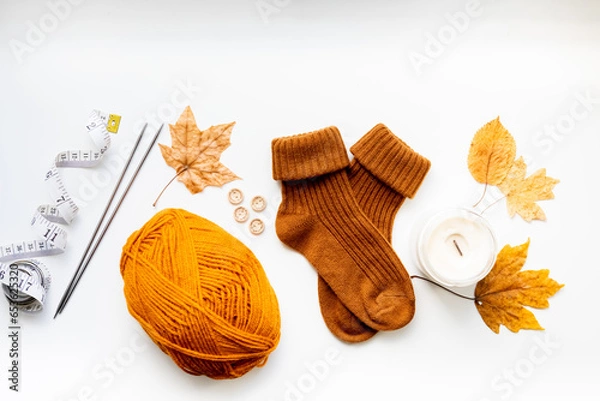 Obraz Set for knitting children's socks. Orange threads, knitting needles, buttons, centimeter.