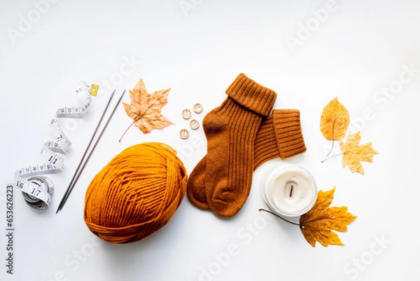 Obraz Set for knitting children's socks. Orange threads, knitting needles, buttons, centimeter.