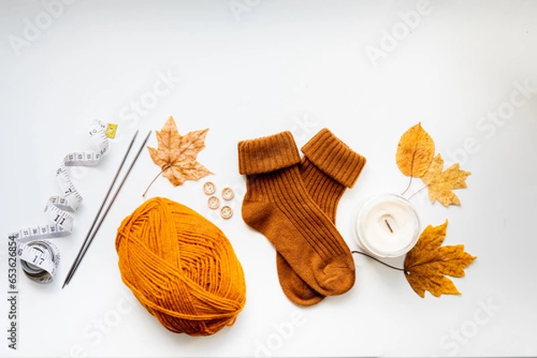 Obraz Set for knitting children's socks. Orange threads, knitting needles, buttons, centimeter.