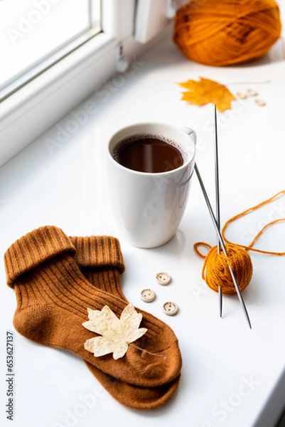 Obraz Set for knitting children's socks. Orange threads, knitting needles, buttons, centimeter.