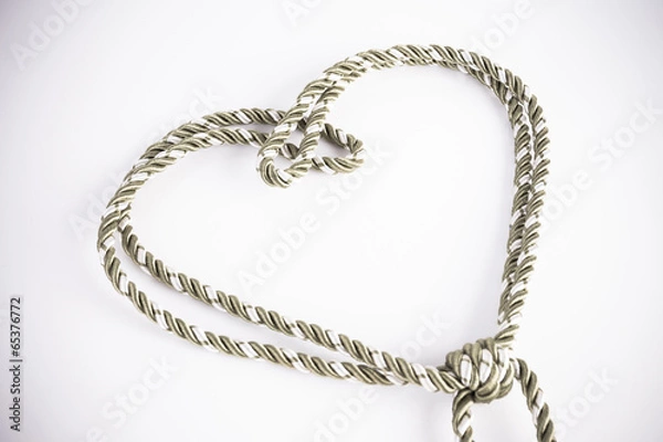 Fototapeta Rope valentine heart of simple design on white with copy space