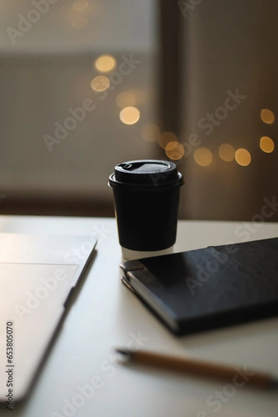 Fototapeta Desk office with laptop, phone, coffee cup, pen on black table. Flat lay top view copy space. Home office. Inspiration moment, workspace or coffee break in the morning. selective focus.