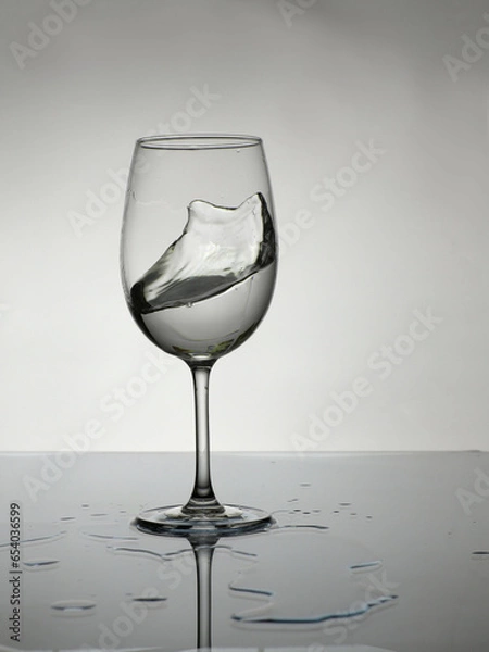 Obraz wine glass with water on a white background with a little splash.