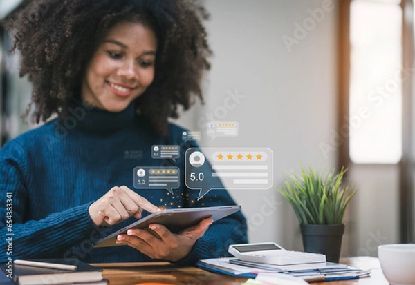Fototapeta Close up of african american customer writing reviews, hand pressing on a smartphone screen with a golden five star rating feedback icon. Concept of rating and feedback for evaluation. Selective focus