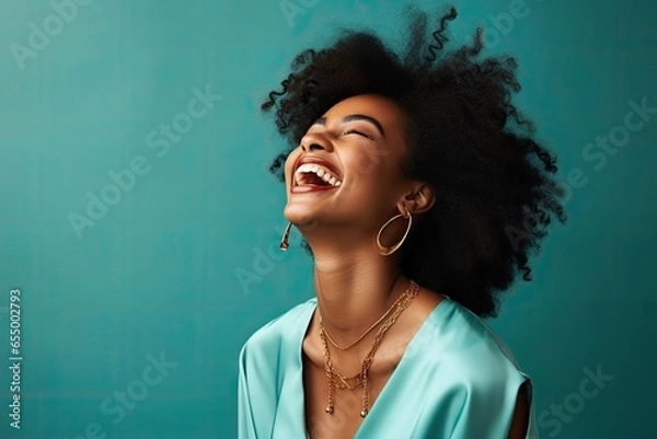 Fototapeta A joyful black woman with her mouth wide open in laughter, expressing pure happiness.