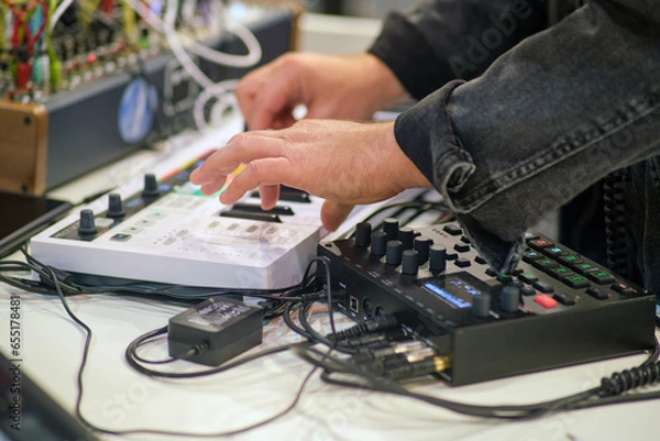 Fototapeta Sound engineer working on a digital sound mixer in a recording studio.