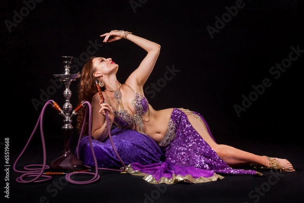 Fototapeta Belly dancer posing with hookah