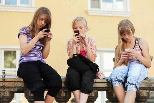 Obraz Group of school girls calling on the cell phones