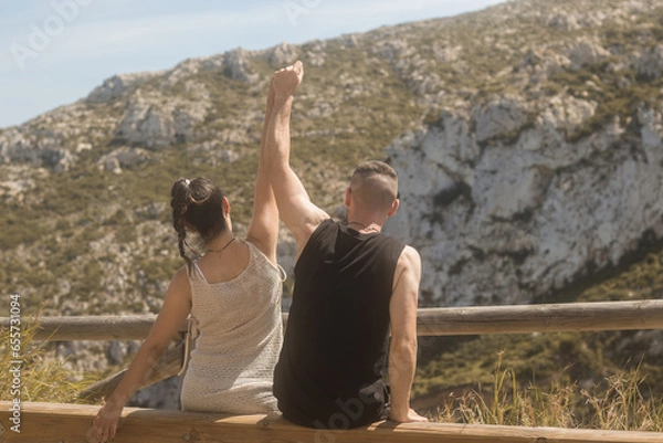 Obraz Young couple in love on a gazebo with their backs turned