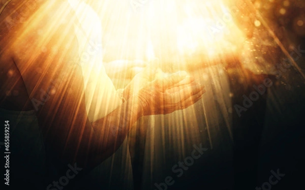 Obraz woman in a ceremonial space. Close-up shot of a woman's hand during the ceremony. Light effect.