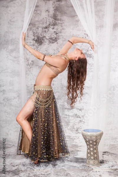 Fototapeta Retro belly dancer in backbend between drapes