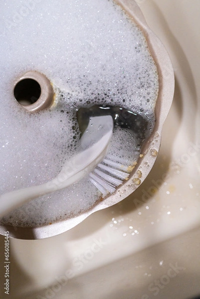 Fototapeta Washing dirty aluminum bundt cake pan