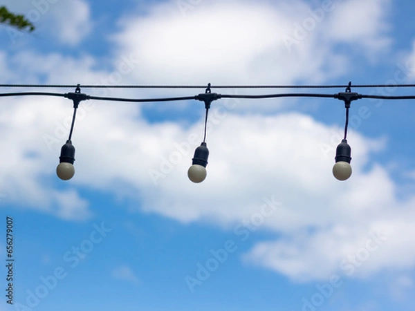 Obraz hanging bulbs on blue sky